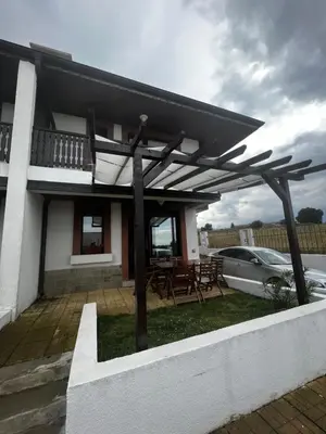 a house with a wooden pergola in the yard at Велика Гардън - Акация 6 in Lozenets