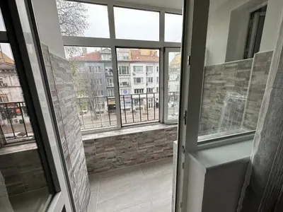an open door to a room with windows at Апартамент Опера. Стил и комфорт. Идеален център. in Varna City