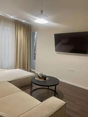a living room with a couch and a table at New luxury furnished apartment - beach, Varna center & fast Wi-FI in Varna City