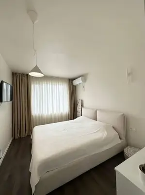 a bedroom with a large white bed in a room at New luxury furnished apartment - beach, Varna center & fast Wi-FI in Varna City