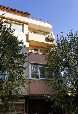 a tall building with trees in front of it at Cozy 1BD Apartment with Free Parking in the Area by Flat Mаnager in Varna City