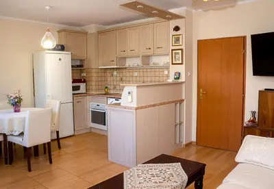 a kitchen with a white refrigerator and a table at Cozy 1BD Apartment with Free Parking in the Area by Flat Mаnager in Varna City