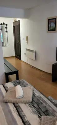 a room with a bed with a phone on the wall at Cozy apartment in the hart of the city in Varna City