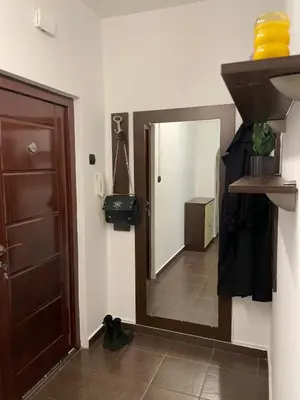 a bathroom with a mirror next to a door at Sity Home in Burgas City