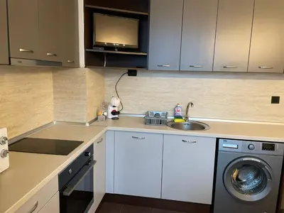 a kitchen with a sink and a washing machine at Sity Home in Burgas City