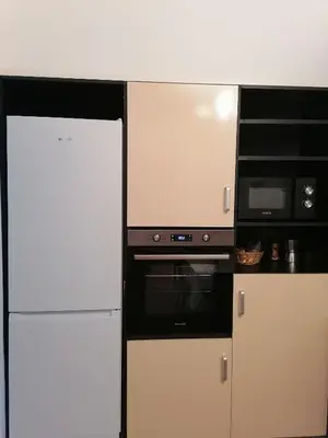 a kitchen with a white refrigerator and a microwave at Оазис 1 във Варна in Varna City