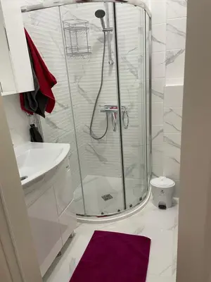 a bathroom with a shower and a purple rug at Sonne, Meer und mehr in Nesebar