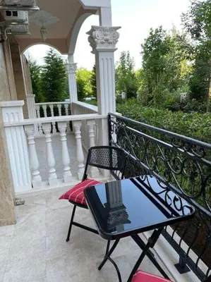 a balcony with a chair and a table on a porch at Sonne, Meer und mehr in Nesebar