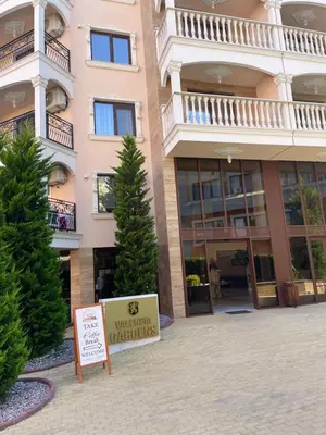 a sign in front of a building with christmas trees at Sonne, Meer und mehr in Nesebar