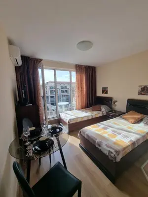a hotel room with two beds and a table and a tableablish at Deluxe Admiral Plaza in Sunny Beach