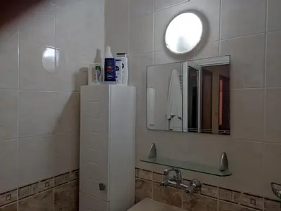 a bathroom with a sink and a mirror at Стая за гости на град Бургас. in Burgas City
