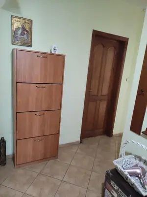 a room with a wooden cabinet and a door at Стая за гости на град Бургас. in Burgas City