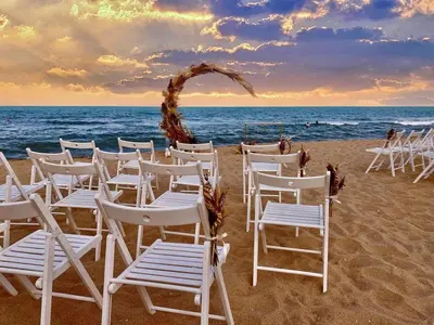 a group of chairs and an arch on the beach at Infinity View Shkorpilovci in Shkorpilovtsi