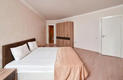 a bedroom with a large white bed in a room at Boutique Rose Gardens Pomorie in Pomorie