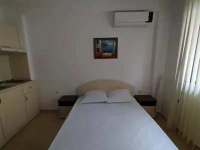 a bedroom with a white bed in a room at Жасмин клуб in Sunny Beach