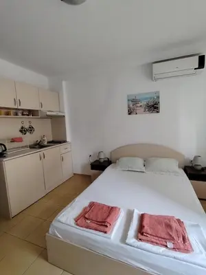 a bedroom with a bed with two towels on it at Жасмин клуб in Sunny Beach