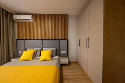 a bedroom with a large bed with yellow pillows at Emilia Romana Park in Sunny Beach