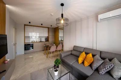 a living room with a couch and a kitchen at Emilia Romana Park in Sunny Beach