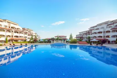 a swimming pool in front of some apartment buildings at Grande Mia Casa in Sveti Vlas