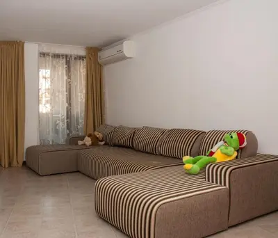 a living room with a couch with stuffed animals on it at Grande Mia Casa in Sveti Vlas