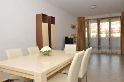 a dining room with a white table and white chairs at Grande Mia Casa in Sveti Vlas