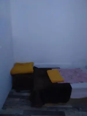 a room with a bed with yellow pillows on it at Апартамент стоенчо хаджииванов,10 in Varna City