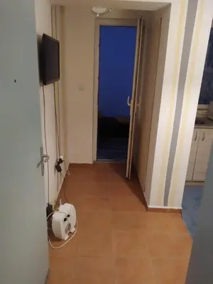 a room with a door that has a white dog laying on the floor at Апартамент стоенчо хаджииванов,10 in Varna City