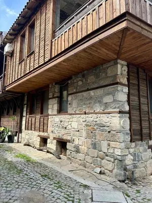a stone building with a bench on the side of it at Sozopol Old Town - Studio 1 in Sozopol