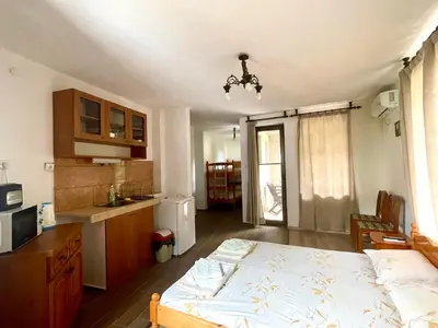 a kitchen with a bed in a room with a kitchen at Sozopol Old Town - Studio 1 in Sozopol