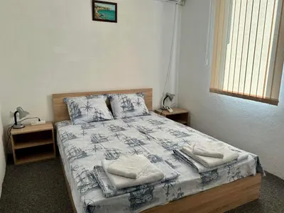 a bedroom with a bed with towels on it at Sozopol Old Town - Apartment 3 in Sozopol