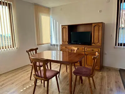 a dining room with a table and a tv at Sozopol Old Town - Apartment 3 in Sozopol