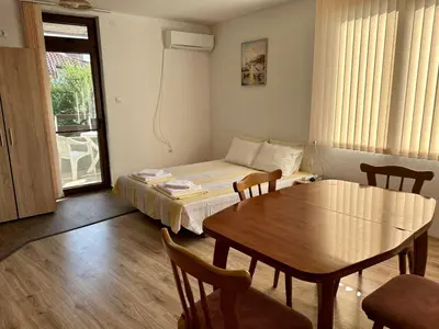 a room with a bed and a table and a dining room at Sozopol Old Town - Apartment 3 in Sozopol
