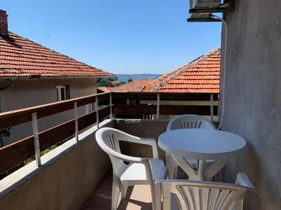 a table and two chairs on a balcony at Sozopol Old Town - Apartment 3 in Sozopol