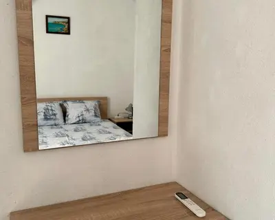 a mirror on a wall with a bed in a room at Sozopol Old Town - Apartment 3 in Sozopol