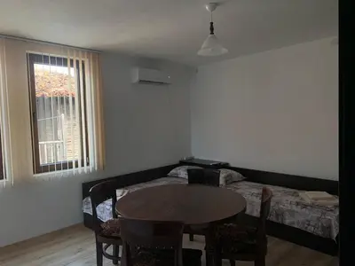 a living room with a table and a bed at Sozopol Old Town - Apartment 4 in Sozopol