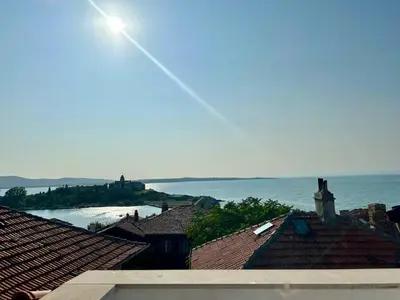 a view of the ocean from the roofs of houses at Sozopol Old Town - Studio 5 Attic in Sozopol