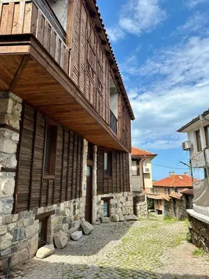 a wooden building with a balcony on the side of it at Sozopol Old Town - Studio 5 Attic in Sozopol