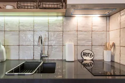 a kitchen counter with a sink and a roll of paper towels at Студио в близост до Община Варна in Varna City