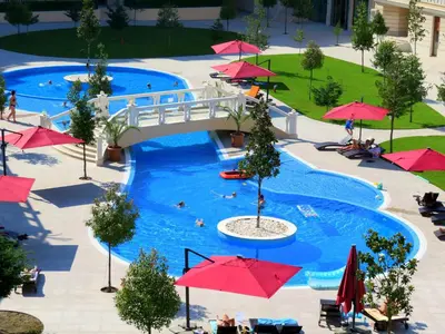 an overhead view of a pool with red umbrellas at Апартаменти Варна Саут на плажа 2 - Varna South Apartments on the beach 2 in Varna City