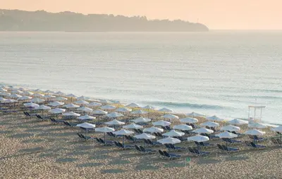 a line of chairs and umbrellas on a beach at Sunrise Splendid in Obzor