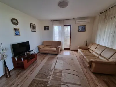 a living room with two couches and a television at Sunrise Splendid in Obzor