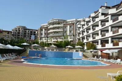 a swimming pool in front of a large building at Студио Sun day в Royal palm, Свети Влас in Sveti Vlas