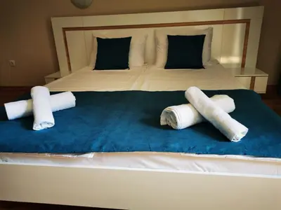 a bed with three rolled up towels on it at Студио Sun day в Royal palm, Свети Влас in Sveti Vlas