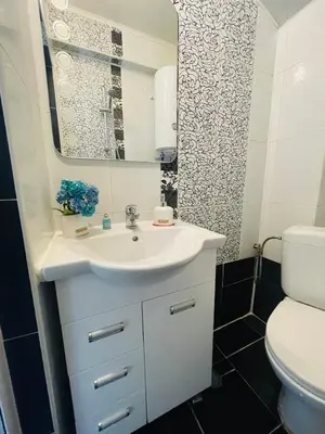a bathroom with a white sink and a toilet at By The Sea - central with free parking in Varna City