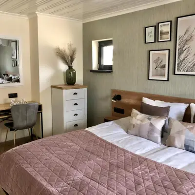 a bedroom with a bed and a desk and a chair at Drive Point (Adventure Lake Resort) in Asparukhovo