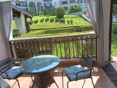a table with a surfboard on it on a balcony at Monastery II Garden stay like home in Sveti Vlas