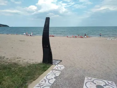 a black sculpture on the beach near the ocean at Курортен коплекс Елените,община Несебър,област Бургас in Emona