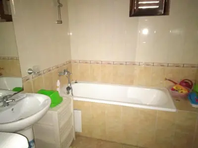 a bathroom with a tub and a toilet and a sink at Курортен коплекс Елените,община Несебър,област Бургас in Emona