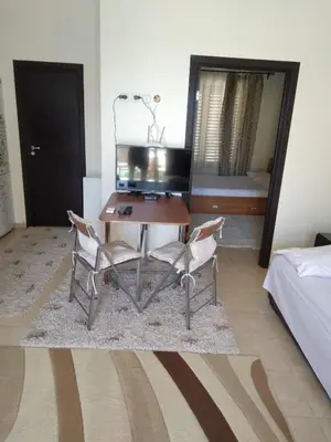 a room with a desk and two chairs and a bed at Курортен коплекс Елените,община Несебър,област Бургас in Emona