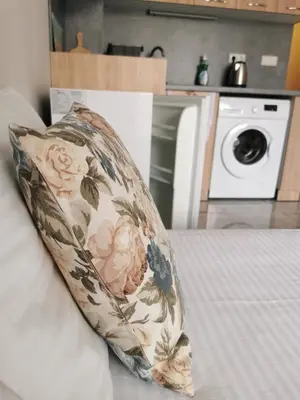 a pillow sitting on a bed with a washing machine at Admiral Plaza Sunrise Apartments C13 in Sunny Beach
